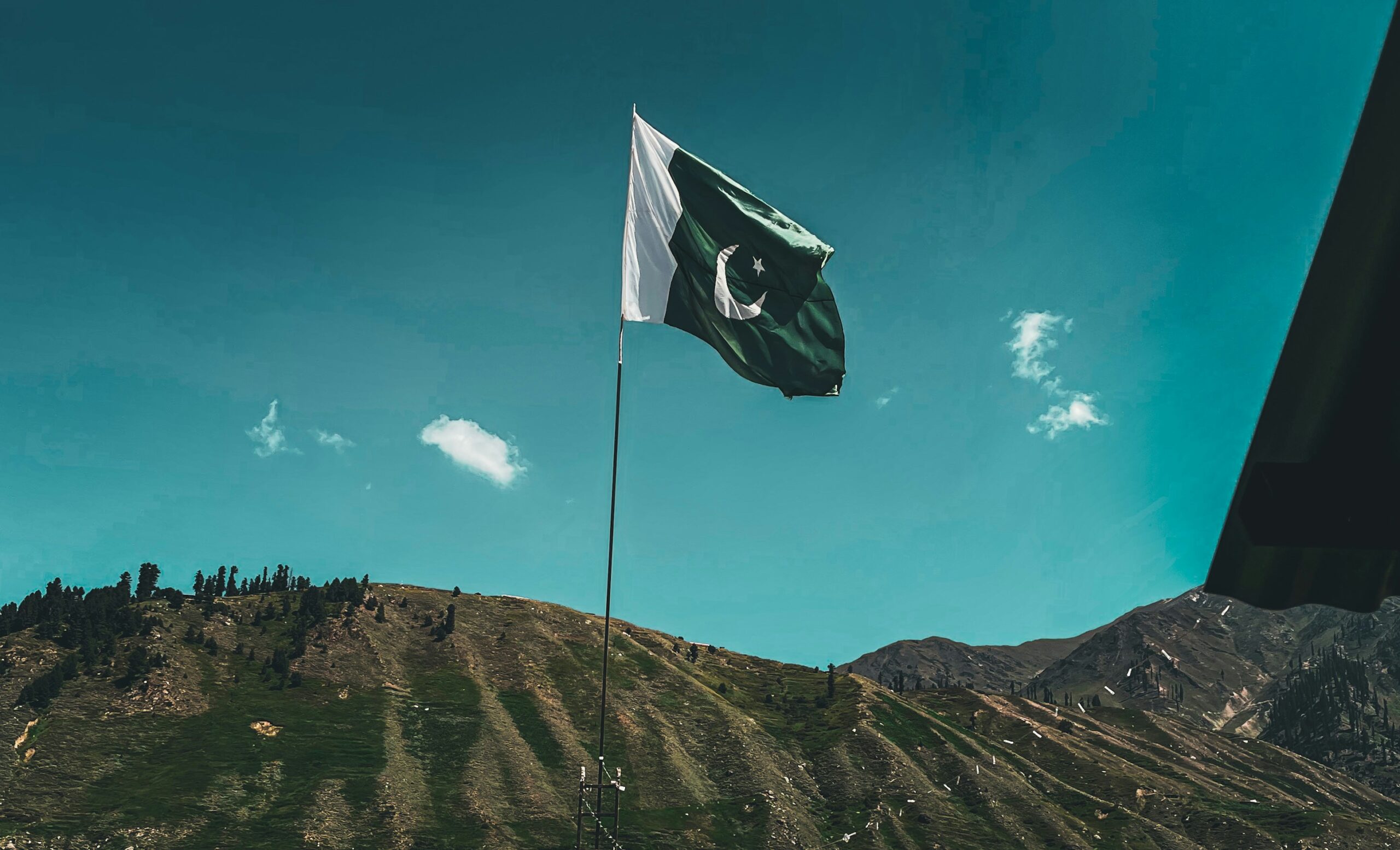 A image of pakistani flag in mountains