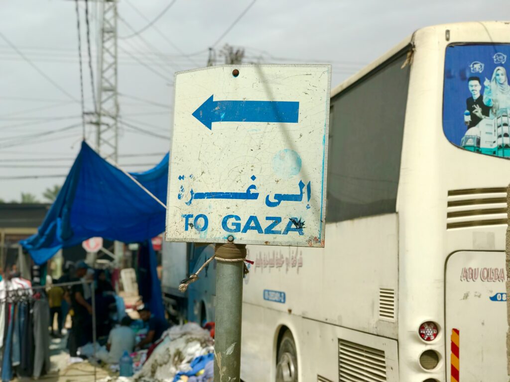 A road sign labeled “Gaza” beside a highway, symbolizing the contested and sensitive geopolitical situation in Gaza within the broader context of tensions surrounding Palestine.
