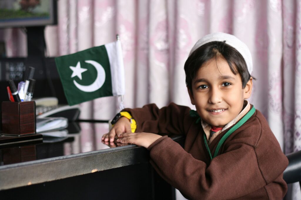 A pakistani boy on the chair wearing school uniform