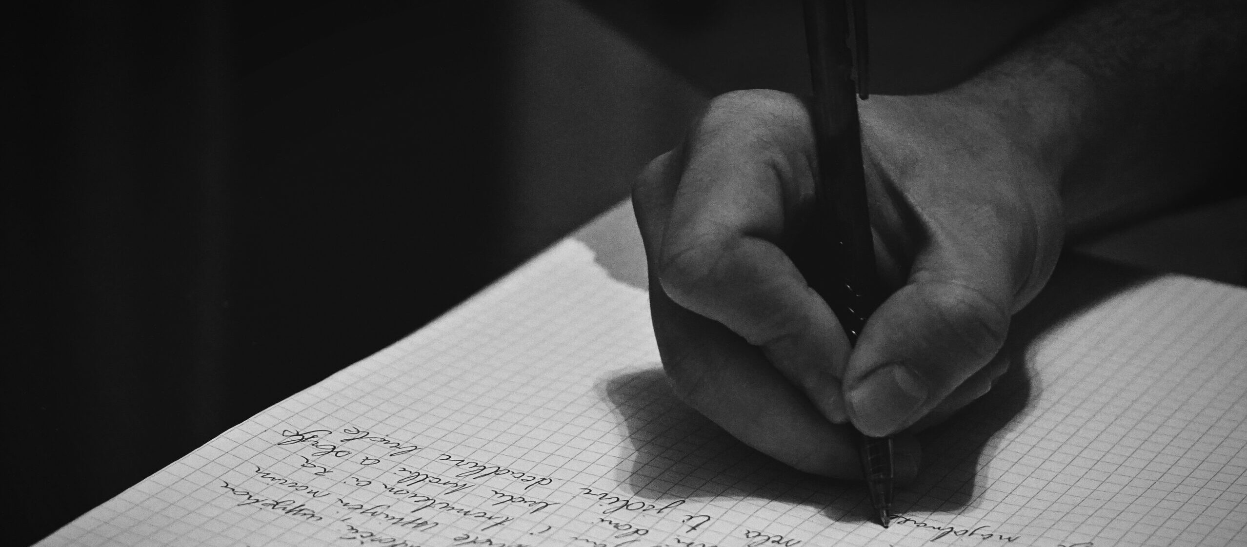 writing with a pen on paper representing nova Essays page