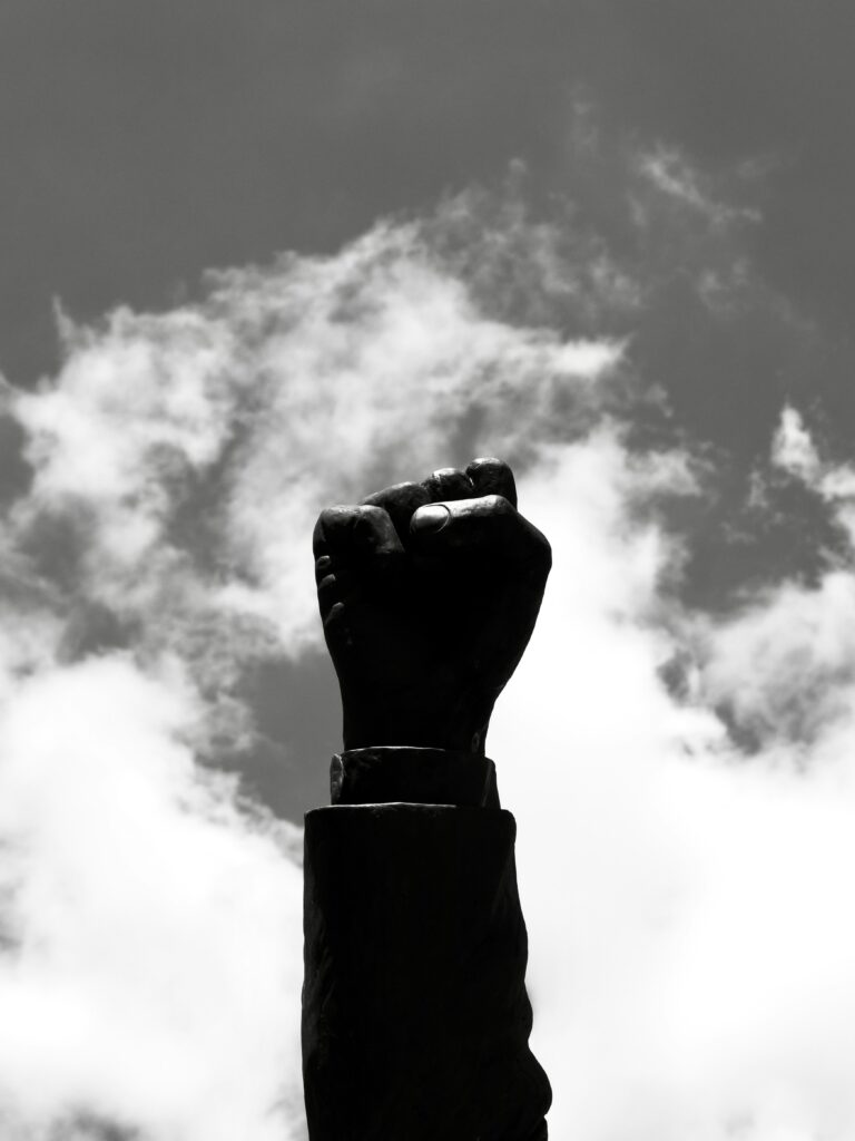 Raised hand symbolizing resistance, youth empowerment, and intellectual awakening