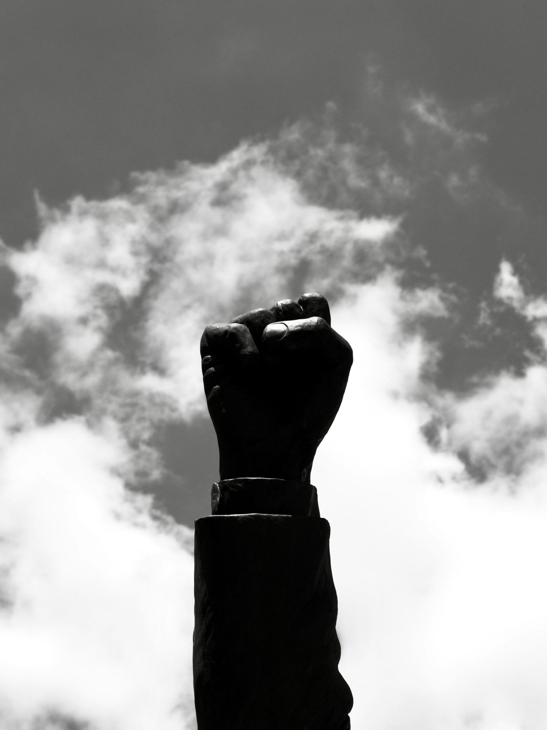 Raised hand symbolizing resistance, youth empowerment, and intellectual awakening