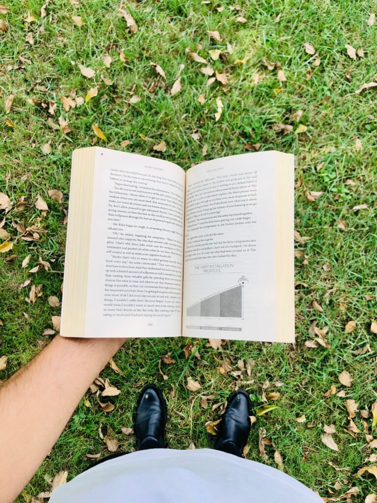 A man reading from the spaiens book highlighting the importance of book reading
